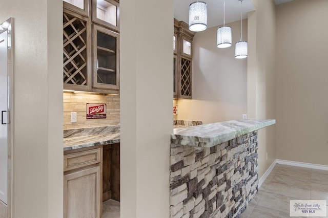 2402 S Christian Cir, Harlingen, TX 78550 - indoor dry bar featuring light marble finish floors, backsplash, and pendant lighting