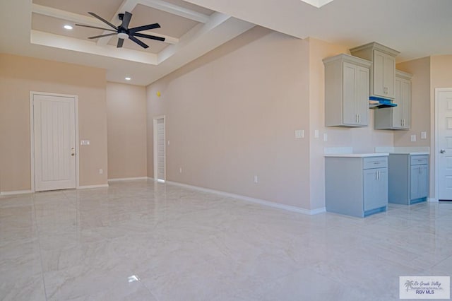 interior space with recessed lighting, under cabinet range hood, coffered ceiling, baseboards, and marble finish floor