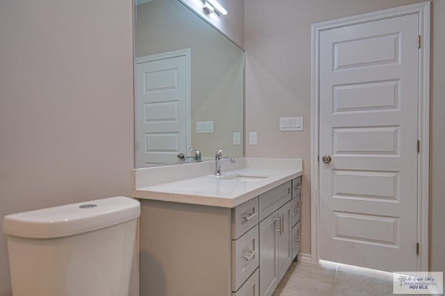 bathroom with toilet and vanity