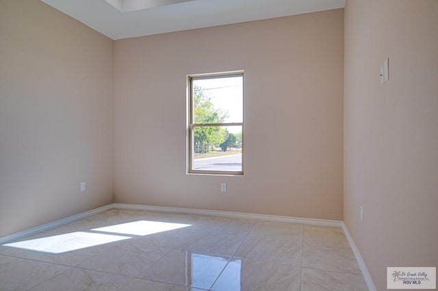 unfurnished room featuring baseboards