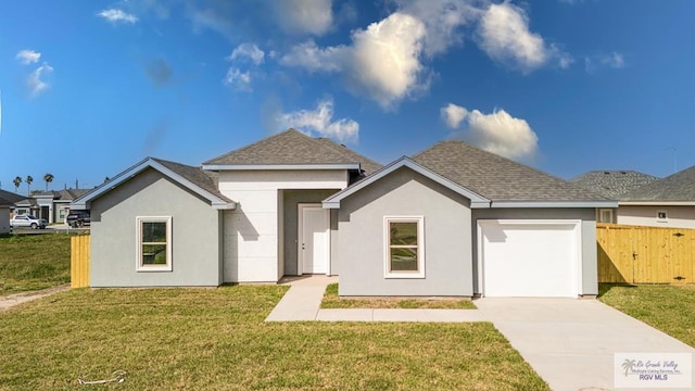 view of front of property with driveway, an attached garage, fence, a front yard, and stucco siding