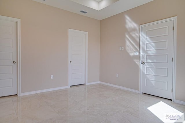 unfurnished room featuring marble finish floor, visible vents, and baseboards