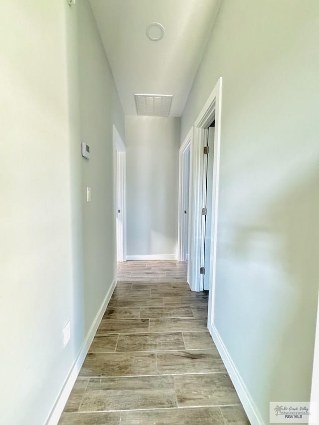 hallway with light hardwood / wood-style floors