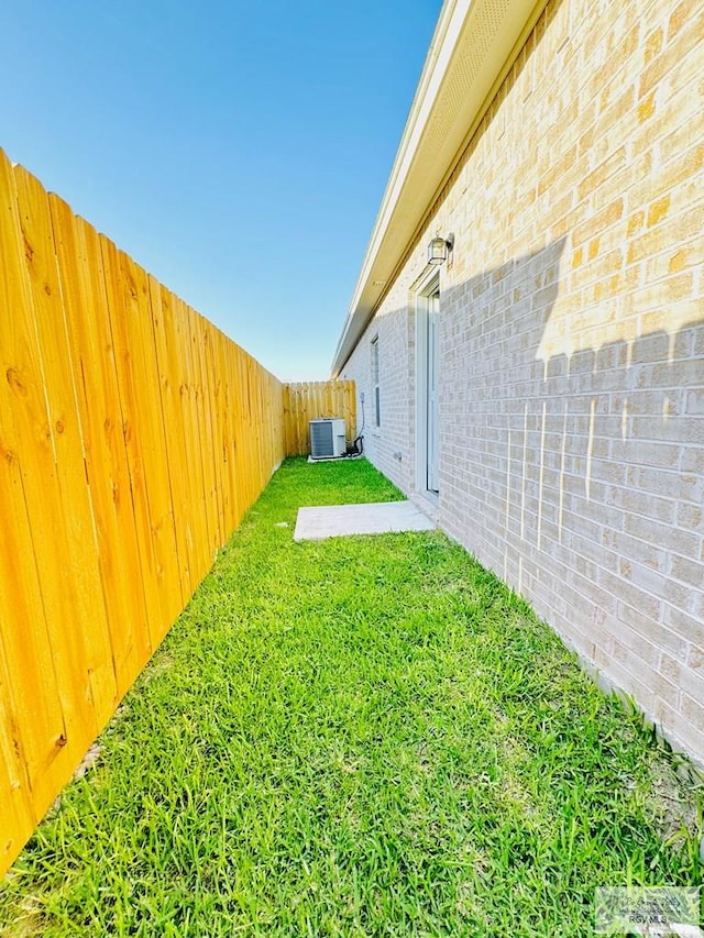 view of yard featuring central AC unit