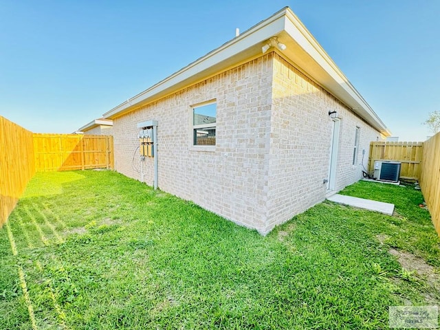 view of property exterior with a yard and central AC