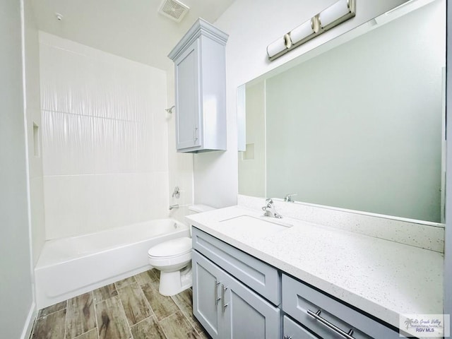 full bathroom with vanity, hardwood / wood-style flooring, toilet, and tub / shower combination