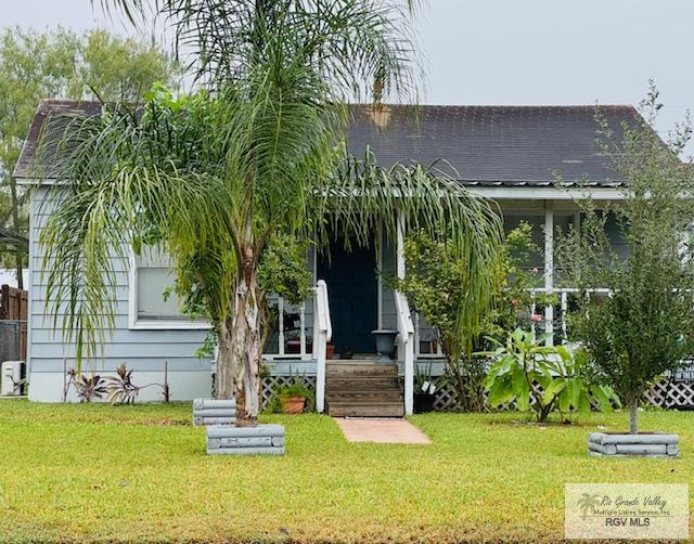 rear view of property featuring a yard