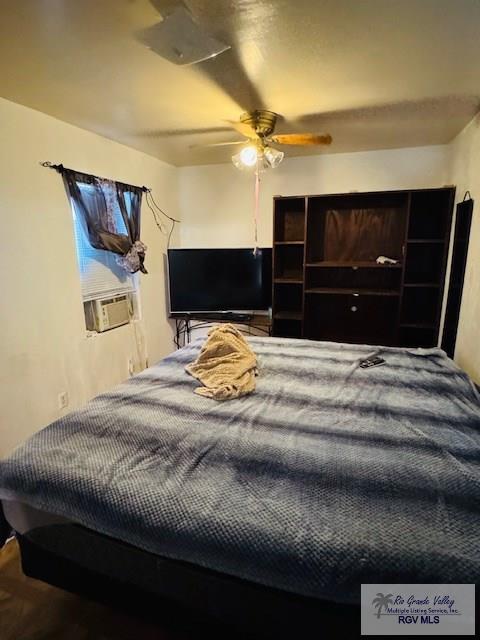 bedroom featuring ceiling fan and cooling unit