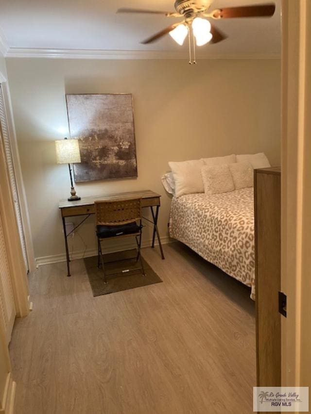 bedroom featuring hardwood / wood-style floors, ceiling fan, and ornamental molding