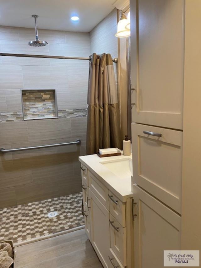 bathroom featuring a shower with curtain, vanity, and hardwood / wood-style flooring