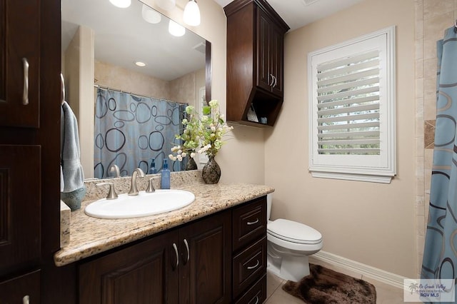 bathroom featuring tile patterned floors, vanity, and toilet