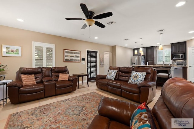 living room with light tile patterned floors and ceiling fan