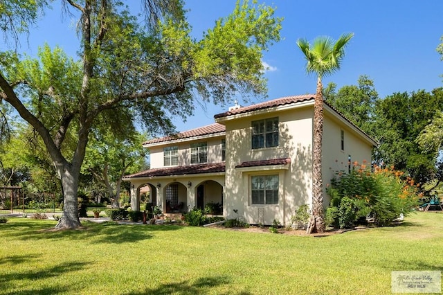 rear view of property with a yard