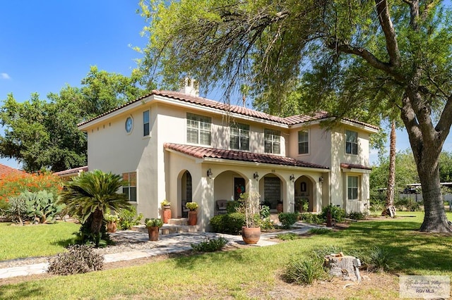 rear view of property featuring a lawn