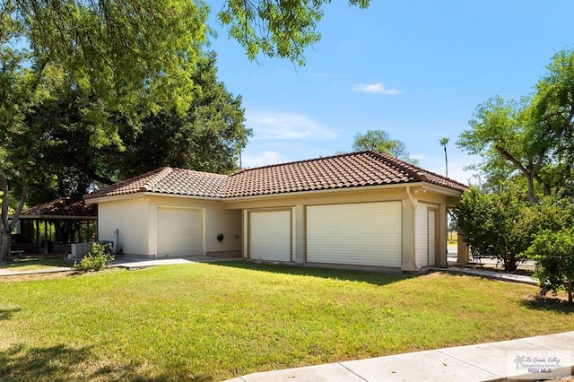 mediterranean / spanish home with a garage and a front lawn