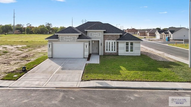 view of front of house with a garage and a front lawn