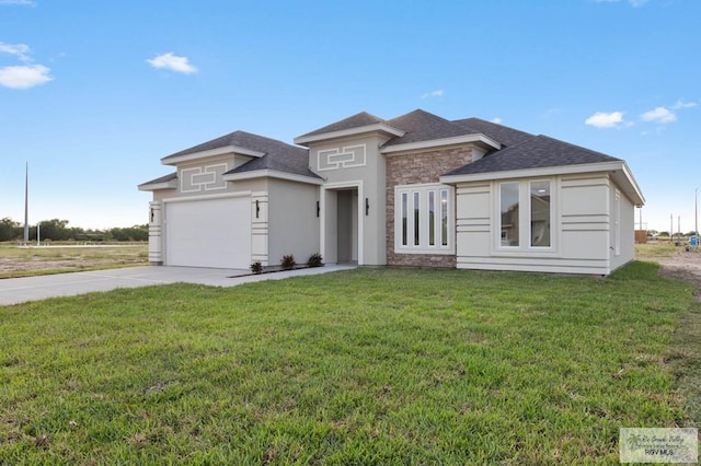 prairie-style home with a garage and a front yard