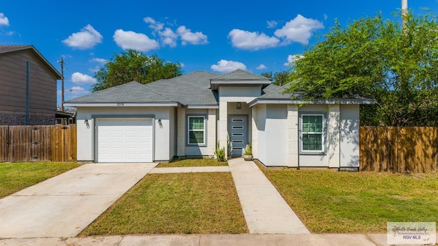 view of front of home with a garage and a front lawn