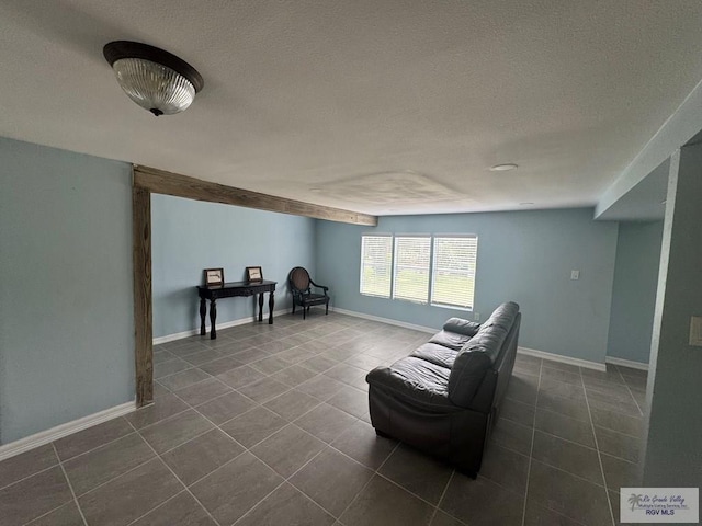 44 Highland Ter, Brownsville, TX 78521 - sitting room with a textured ceiling, dark tile patterned flooring, and baseboards
