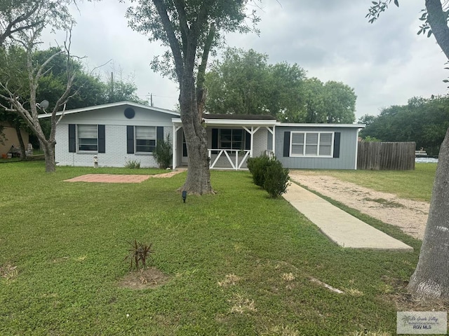 44 Highland Ter, Brownsville, TX 78521 - ranch-style house with a front yard, a porch, and brick siding