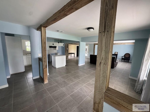 44 Highland Ter, Brownsville, TX 78521 - unfurnished living room with dark tile patterned floors and baseboards