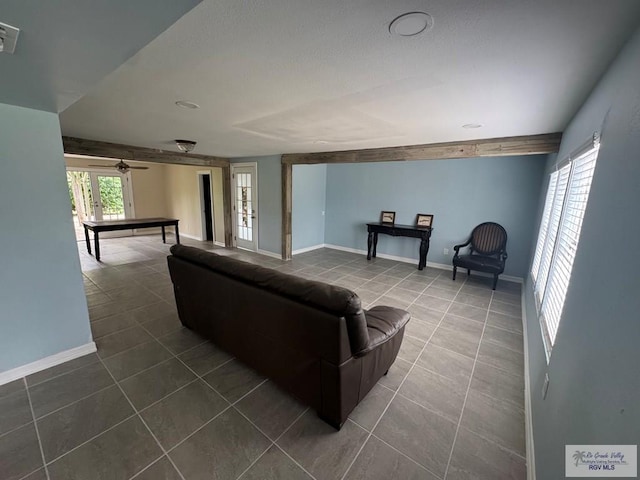 44 Highland Ter, Brownsville, TX 78521 - living room featuring dark tile patterned floors, baseboards, and a ceiling fan