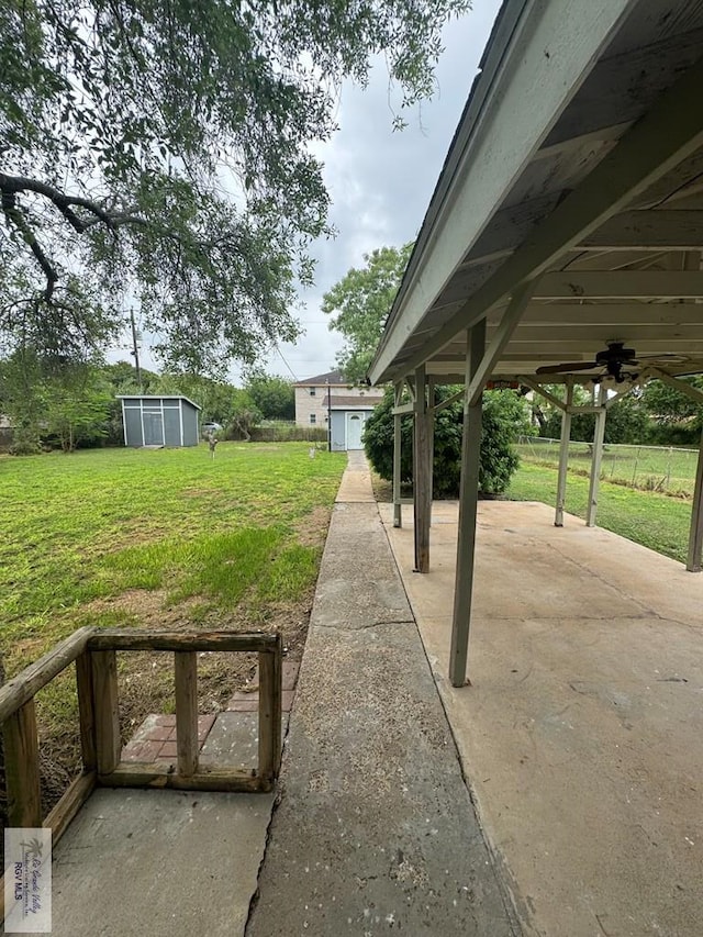 44 Highland Ter, Brownsville, TX 78521 - view of green lawn featuring a patio area, an outbuilding, and a ceiling fan