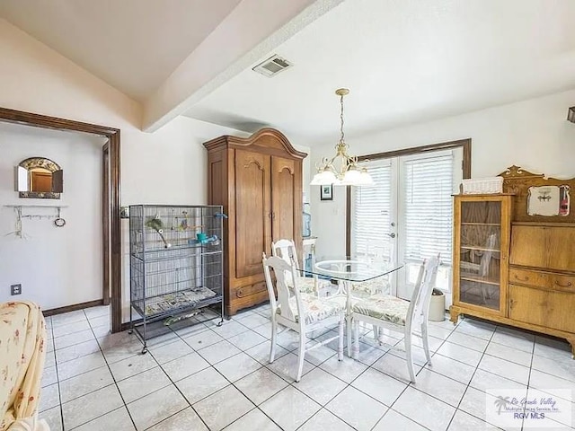 dining area with a notable chandelier, vaulted ceiling, and light tile patterned floors