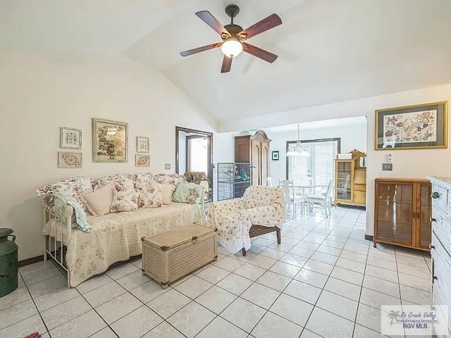 living room with ceiling fan, lofted ceiling, and light tile patterned floors