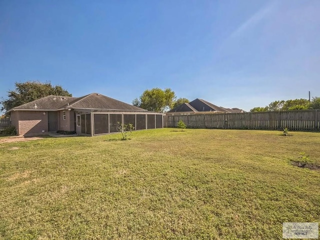 view of yard featuring a sunroom