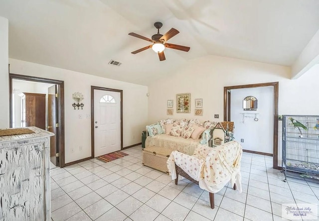 living room featuring lofted ceiling, light tile patterned floors, and ceiling fan