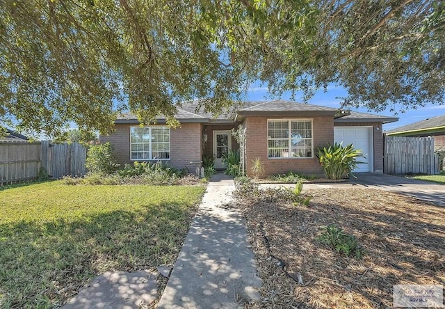 ranch-style home with a garage and a front yard