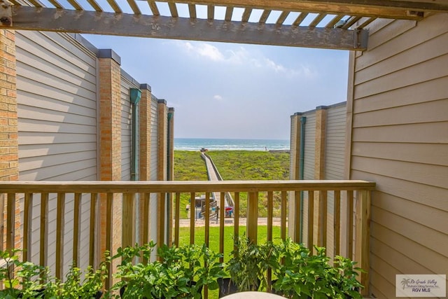 balcony featuring a water view and a pergola