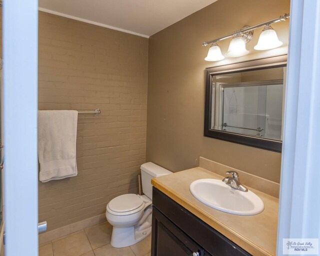 bathroom with a shower, vanity, toilet, and tile patterned floors