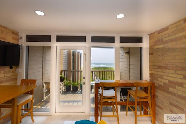 interior space featuring recessed lighting and brick wall