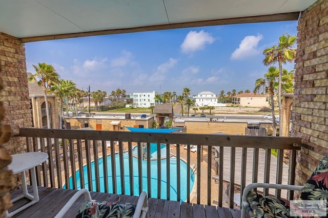 wooden deck featuring a community pool