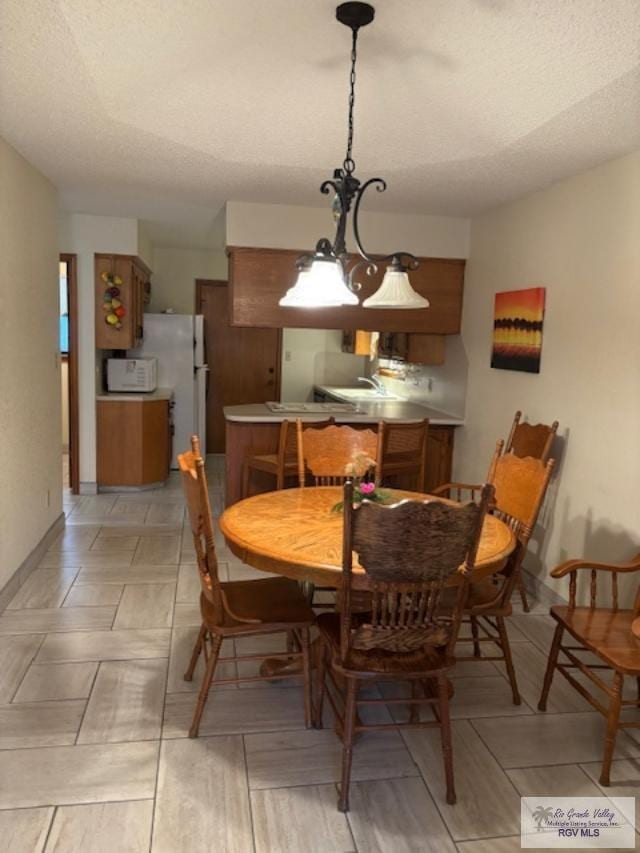 dining room featuring a textured ceiling
