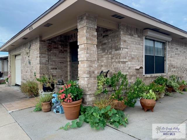 view of side of home featuring brick siding