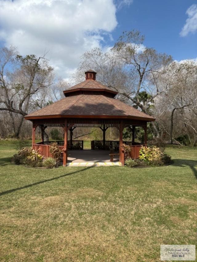 view of property's community with a yard and a gazebo