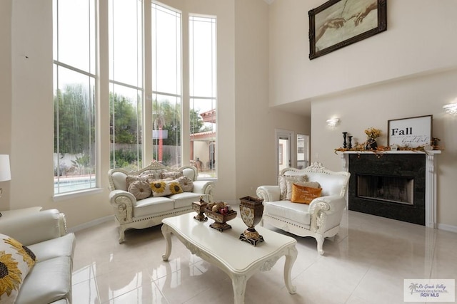 5454 Dragon Wick, Brownsville, TX 78526 - tiled living room featuring a high end fireplace and a high ceiling