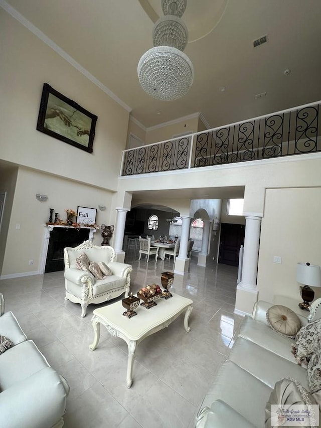 5454 Dragon Wick, Brownsville, TX 78526 - living room with ornate columns, a high ceiling, arched walkways, and crown molding
