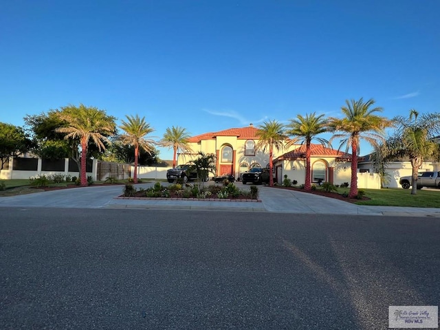 5454 Dragon Wick, Brownsville, TX 78526 - mediterranean / spanish-style home featuring curved driveway and stucco siding