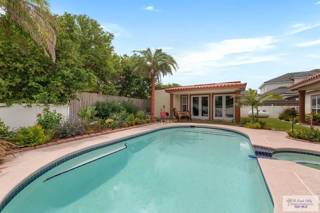 5454 Dragon Wick, Brownsville, TX 78526 - view of pool featuring french doors, an in-ground hot tub, a fenced backyard, and a patio area