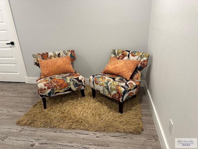 sitting room with wood finished floors and baseboards