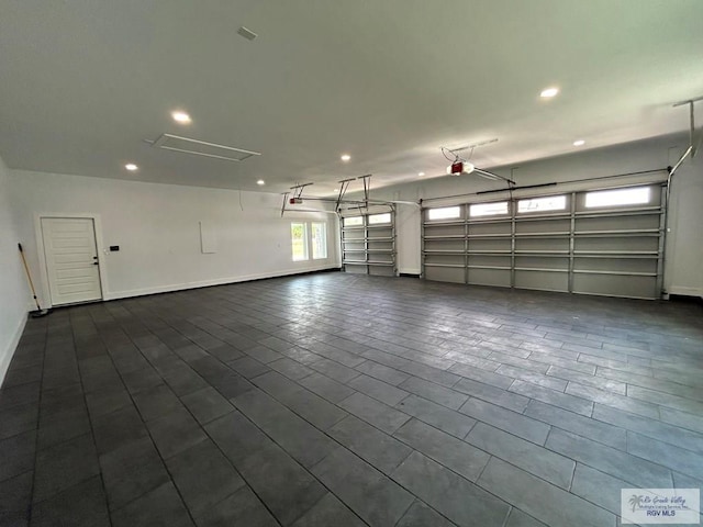 garage with recessed lighting and baseboards