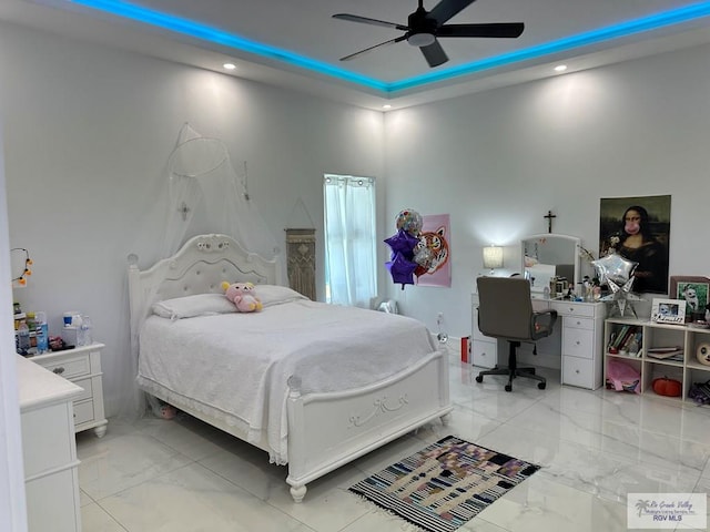 bedroom featuring marble finish floor, a raised ceiling, a ceiling fan, and recessed lighting