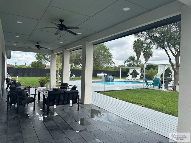 view of patio / terrace featuring ceiling fan, a fenced backyard, and a fenced in pool