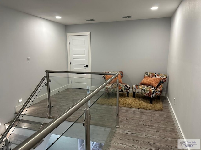 staircase with recessed lighting, visible vents, baseboards, and wood finished floors