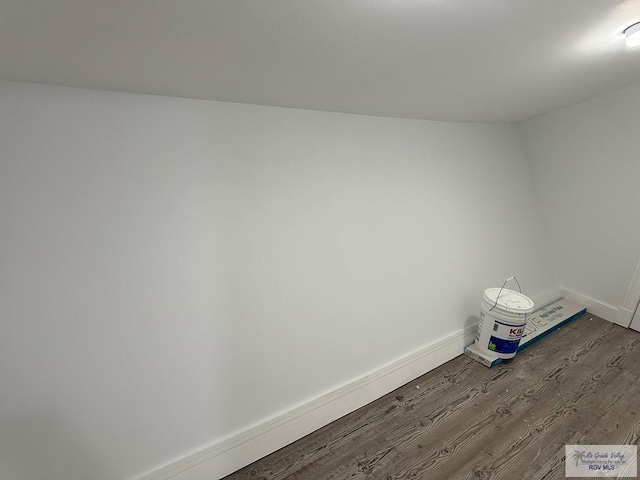 spare room featuring wood finished floors and baseboards