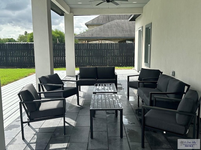 view of patio with fence, an outdoor living space, and ceiling fan